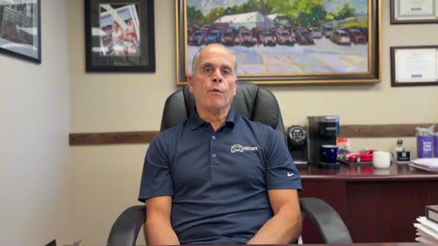 AllCars co-founder John Gabriele in the dealership office explaining why AllCars.com was built